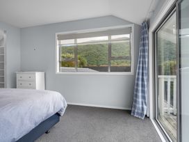 A bedroom with a bed and window at Bayview Haven - Waikawa Retreat, Picton