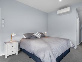A bedroom with a bed and bedside table at Bayview Haven - Waikawa Retreat in Picton