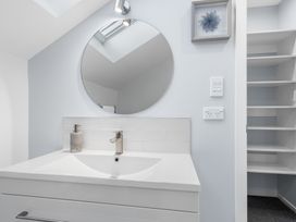 A bathroom with a sink and mirror at Bayview Haven - Waikawa Retreat in Picton