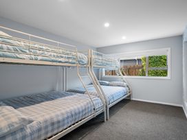 A bedroom with a bunk bed and a single bed at Bayview Haven - Waikawa Retreat in Picton