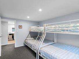 A bedroom with bunk beds and a doorway at Bayview Haven - Waikawa Retreat, Picton