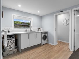 A laundry room with a washing machine and sink at Bayview Haven - Waikawa Retreat in Picton