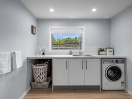 A laundry room with a washing machine and sink at Bayview Haven - Waikawa Retreat in Picton