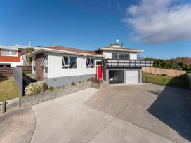 A house with a red door and garage at Taupo view road holiday home in Taupo