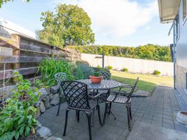 A garden with table and chairs at Taupo view road holiday home Taupo