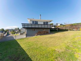 A house with a balcony and wood pile at Taupo view road holiday home in Taupo