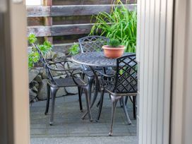 An outdoor seating area with a table and chairs at Taupo view road holiday home Taupo