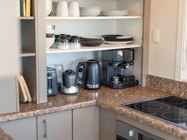 A kitchen with appliances and dishware at Taupo view road holiday home in Taupo
