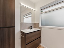 A bathroom with a sink and mirror at Taupo view road holiday home in Taupo