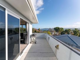 An outdoor balcony with furniture and a view at Taupo view road holiday home Taupo