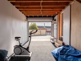 A garage with an exercise bike and a bench at Taupo view road holiday home in Taupo