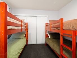 A bedroom with bunk beds and a closet at Kaikoura