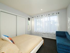 A bedroom with a bed and sofa at Kaikoura