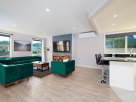 A living room with sofa coffee table and television at Kaikoura