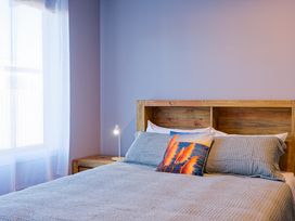 A bedroom with a bed and lamp at Kaikoura