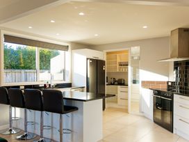 A kitchen with a black refrigerator and an oven at Kaikoura