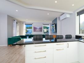 A kitchen with counter and bar stools at Mountain View - Kaikoura Holiday Home, Kaikoura