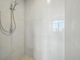 A shower with tiled walls and a window at The Alpine Edge - Windwhistle Holiday Home in Canterbury