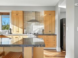 A kitchen with cabinets and stove at The Alpine Edge - Windwhistle Holiday Home in Canterbury