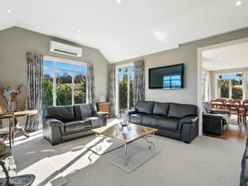 A living room with a sofa and coffee table at The Alpine Edge - Windwhistle Holiday Home in Canterbury
