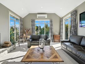 A living room with two sofas and a coffee table at The Alpine Edge - Windwhistle Holiday Home, Canterbury