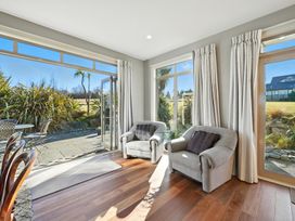 A snug area with two chairs and a table at The Alpine Edge - Windwhistle Holiday Home, Canterbury
