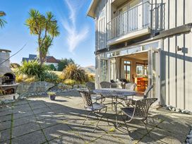 An outdoor patio with a table and chairs at The Alpine Edge - Windwhistle Holiday Home, Canterbury