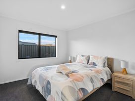 A bedroom with a bed and nightstands at Sunrise Hideaway - Cromwell