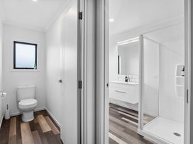 A bathroom with a toilet, sink, and shower at Sunrise Hideaway - Cromwell Holiday Home, Cromwell