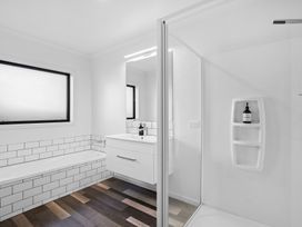 A bathroom with a bathtub, shower, and vanity at Sunrise Hideaway - Cromwell