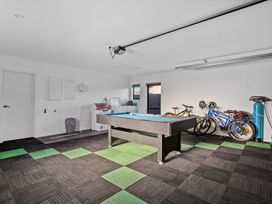 A garage with a billiard table and bicycles at Sunrise Hideaway - Cromwell Holiday Home, Cromwell