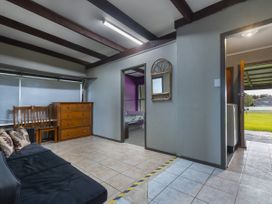 A living room with a sofa and furniture at Natives Nest - Karikari Peninsula Escape Kaitaia