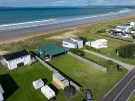An outdoor view with beach and houses at Natives Nest - Karikari Peninsula Escape, Kaitaia