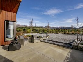An outdoor area with chairs and a bean bag at Eight on Jackson - Luggate Holiday Home