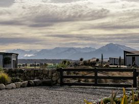 A view of mountains and buildings at Eight on Jackson - Luggate Holiday Home