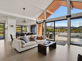 A living room with a sofa and coffee table at Eight on Jackson - Luggate Holiday Home