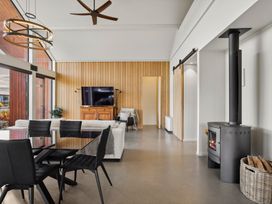 A living room with a sofa and television at Eight on Jackson - Luggate Holiday Home