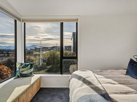 A bedroom with a bed and a view at Eight on Jackson - Luggate Holiday Home
