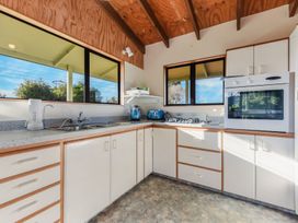 A kitchen with sink, cabinets and appliances at Quail Rise - Collingwood Holiday Home in Collingwood
