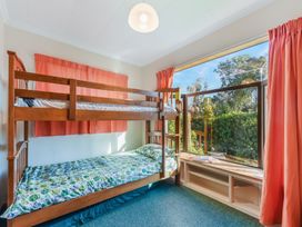 A bedroom with a bunk bed and a window at Quail Rise - Collingwood Holiday Home in Collingwood