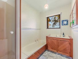 A bathroom with a bathtub and sink at Quail Rise - Collingwood Holiday Home in Collingwood