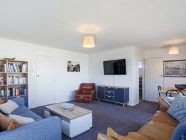 A living room with seating and a television at The Beach Base - Paraparaumu Holiday home in Paraparaumu
