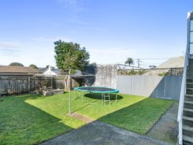 A garden with a trampoline and a clothesline at The Beach Base - Paraparaumu Holiday home, Paraparaumu