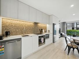 A kitchen with modern appliances at Townheart on Hereford - Christchurch City Apartment
