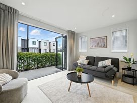 A living room with a sofa and coffee table at Townheart on Hereford - Christchurch City Apartment