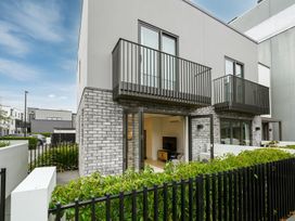 An exterior view of a modern apartment with balconies at Townheart on Hereford - Christchurch City Apartment