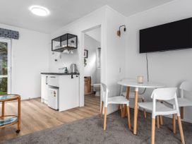 A kitchen with a round table and chairs at Ohope in Ohope