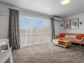 A living room with a sofa and coffee table at Ohope