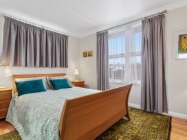A bedroom with a bed and window at Ohope in Ohope
