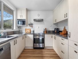 A kitchen with appliances and cabinets at Ohope Ohope